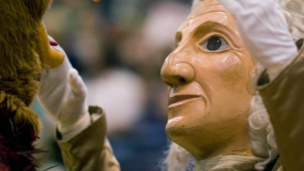 Saint Josephs Hawks mascot and the George Washington Colonials mascot confront each other prior to the start of a game.
